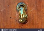 Hand Shaped Golden Door Knob On Brown Wooden Door On Valencia Spain within dimensions 1300 X 956