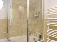 Folding Glass Shower Doors On Bath In Modern Bathroom With Neutral regarding dimensions 1057 X 1390
