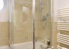 Folding Glass Shower Doors On Bath In Modern Bathroom With Neutral within size 1057 X 1390